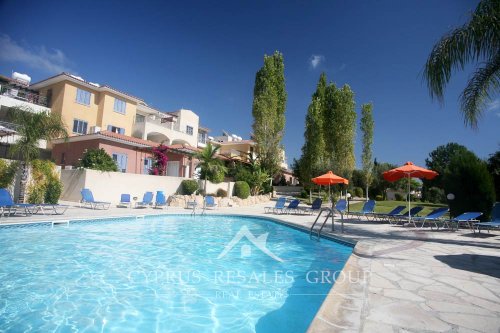 Swimming pool patio of apartments in Pafilia Tala Gardens - enjoy the sun and tranquility of the Mediterranean in Cyprus